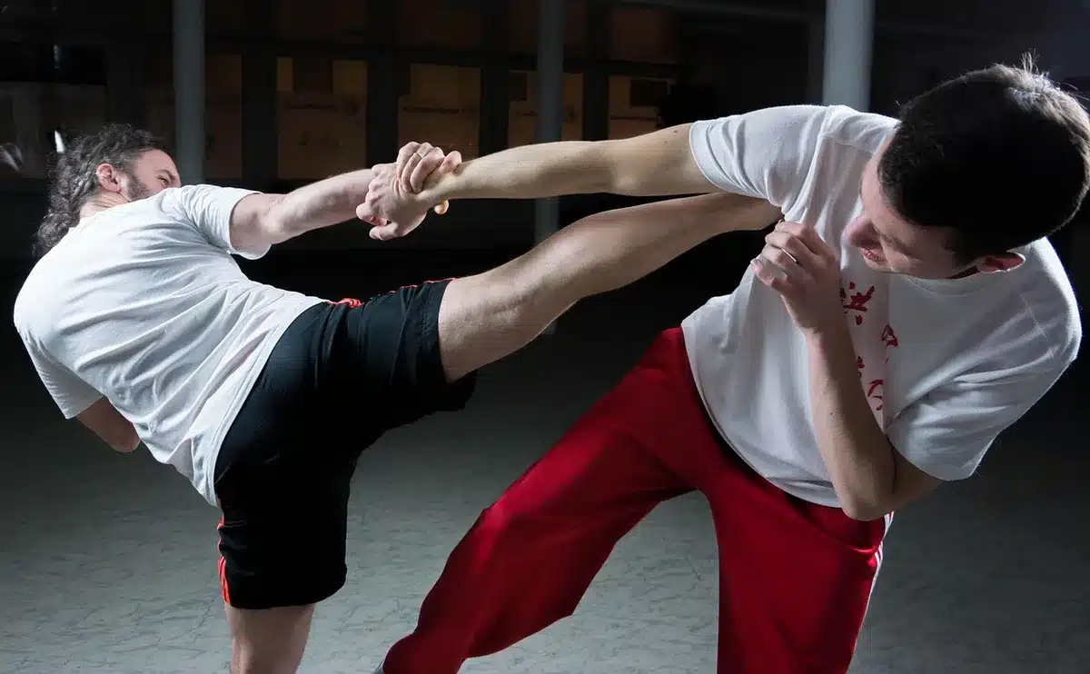 Débutant effectuant un squat avec une barre légère et supervision